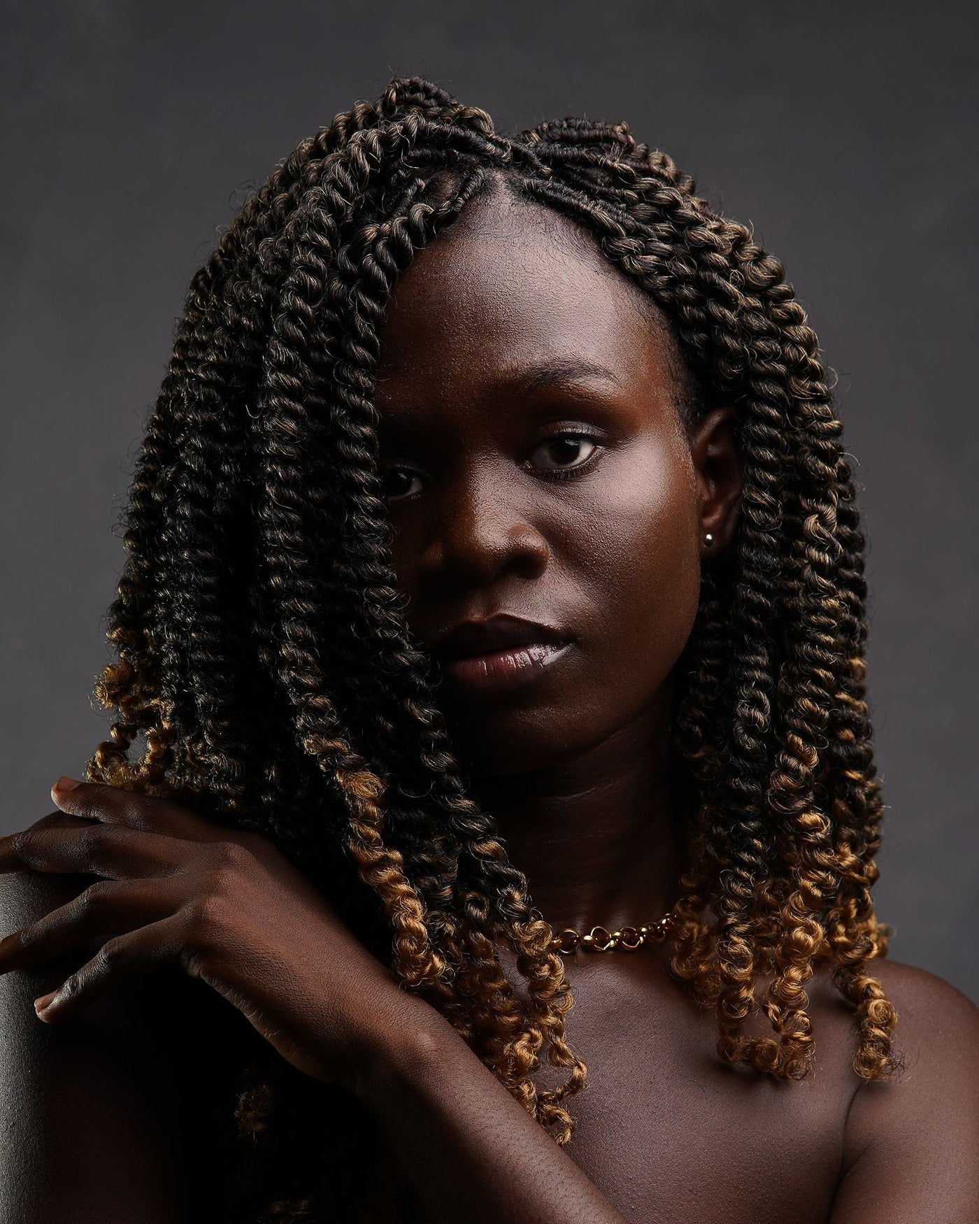 Portrait of a woman with natural curly hair during her transition from relaxed to natural hair