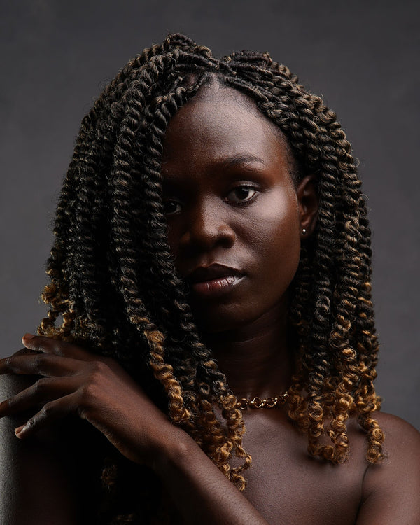 Portrait of a woman with natural curly hair during her transition from relaxed to natural hair